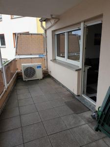 a balcony with a air conditioner next to a window at Ferienwohnung Calabria Nr 2 in Mülheim an der Ruhr