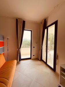 a living room with a couch and a large window at Casa Serra in Porto Palo