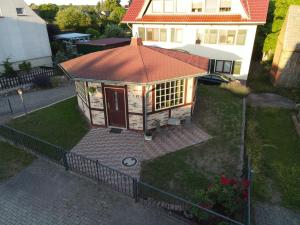 a small house with a roof on a yard at Ferienhaus Priepert in Priepert