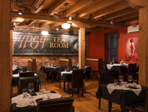 a restaurant with tables and chairs and a sign on the wall at Murray Premises Hotel in St. John's