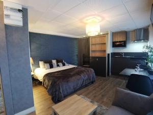a hotel room with a bed and a couch at Au Saint Martin 2 in Cholet