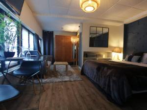 a hotel room with a bed and a table and chairs at Au Saint Martin 2 in Cholet