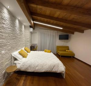 a bedroom with a bed and a stone wall at B&B DA NONNA ANACLE in Bastia Umbra