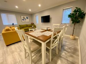 a dining room and living room with a table and chairs at Stylish Hollywood Townhouse - Ideal Location in Los Angeles