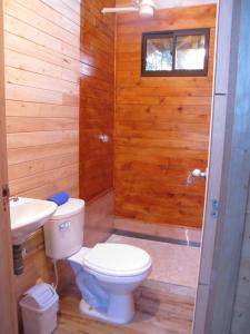 a bathroom with a toilet and a sink at Crisantema 2 in Santa Elena