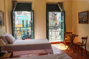 a hotel room with two beds and a view of the city at Hotel Cruz do Pascoal in Salvador