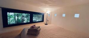 a bedroom with a bed and a large window at Casa Serra in Porto Palo