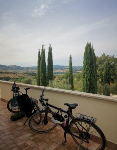 two bikes parked on a balcony with a view at Casale Terre Rosse in Saturnia