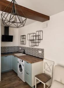 a kitchen with a washer and dryer in a room at Casa iulia in Haro