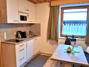 a small kitchen with a table and a window at Gästehaus Biobauernhof Mandl in Murau