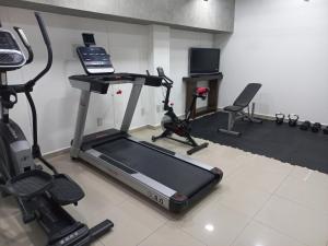 a room with a gym with a treadmill and exercise bikes at Suites Copérnico Polanco Anzures in Mexico City