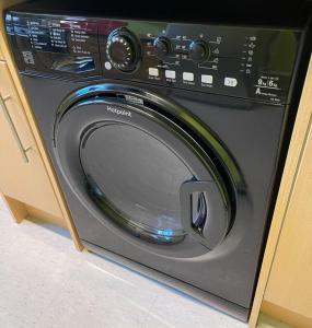 a washing machine with its door open in a kitchen at PHOENIX Boutique Apartments in Goole