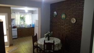 a kitchen with a table and a brick wall at FINCA VERDE in La Falda