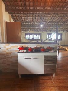 a kitchen with a stove with pots and pans on it at Apartamento rústico in Cabo Frio