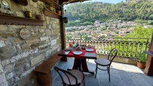 a table and chairs on a balcony with a view at Timo's Guest House in Berat