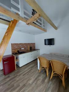 a kitchen with a table and two chairs in a room at Chatka Podgórna in Podgórzyn