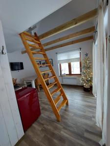 a staircase in a room with a christmas tree at Chatka Podgórna in Podgórzyn