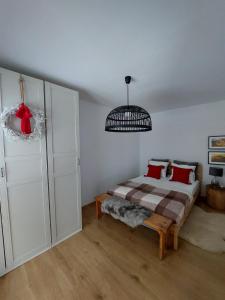 a bedroom with a bed and a chandelier at Chatka Podgórna in Podgórzyn