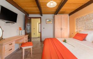 a bedroom with a bed with a desk and a television at Villa Marko in Buje +38 photos