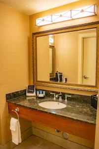 a bathroom with a sink and a mirror at Three Rivers Casino Resort in Florence