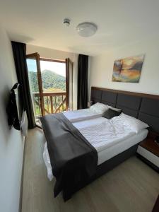 Ένα ή περισσότερα κρεβάτια σε δωμάτιο στο MK Apartments Zoned 2 Spa&Wellness