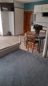 a room with a table and a kitchen with a dining room at Aux doux refuges de la muse Studio in Montjaux +16 photos