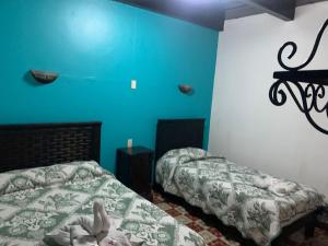 Postel nebo postele na pokoji v ubytování Hotel Clasico Colonial