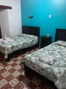 Postel nebo postele na pokoji v ubytování Hotel Clasico Colonial
