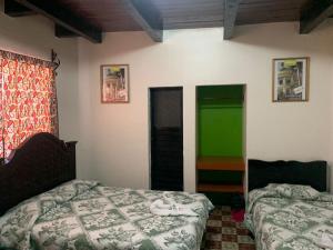 Postel nebo postele na pokoji v ubytování Hotel Clasico Colonial