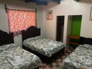 Postel nebo postele na pokoji v ubytování Hotel Clasico Colonial