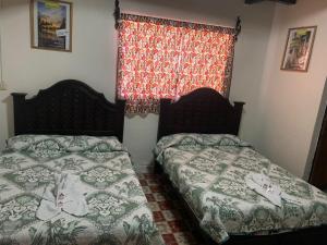 Postel nebo postele na pokoji v ubytování Hotel Clasico Colonial