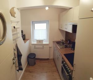 a small kitchen with a sink and a window at Ferienwohnung Schleeff in Elsfleth