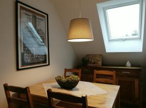 a dining room table with a bowl of flowers on it at Ferienwohnung Schleeff in Elsfleth
