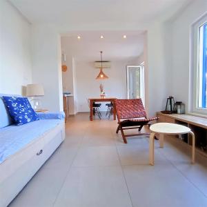 a living room with a couch and a chair and a table at Mljet 4You - Beach House in Sobra