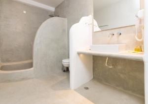 a bathroom with a sink and a toilet and a tub at Princess Of Naxos in Naxos Chora