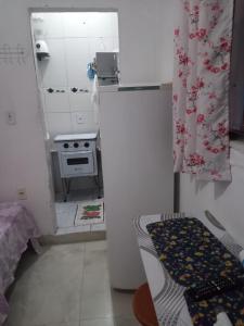 a small kitchen with a refrigerator and a stove at kitnet Maysa em Benfica RJ in Rio de Janeiro