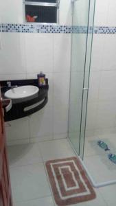 a bathroom with a glass shower and a sink at Casa Logan - Condomínio Village, Casa 15 in Maragogi +15 photos