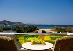a plate of grapes on a table on a balcony at Princess Of Naxos in Naxos Chora