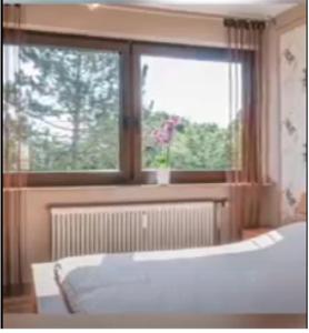 a bedroom with a bed and a large window at Miaos private Room in Sindelfingen
