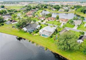 an aerial view of a house on an island in the water at Beautiful Waterfront Home with Heated Pool and Game Room in Davenport
