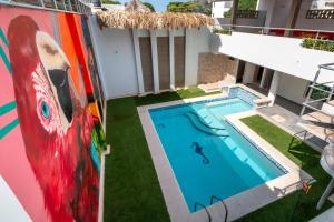 a house with a pool and a painting on the side of it at Hotel Boutique Casa chunuu Santa Marta in Santa Marta