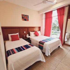 Postel nebo postele na pokoji v ubytování Hotel Machos Mahahual