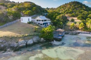 an aerial view of a house in the water at Exclusive Beachfront Eco studio in Hermitage