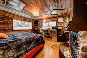 a bedroom in a log cabin with a bed and a fireplace at The Oasis on Eisenhower in Loveland