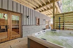 a large bathroom with a large tub in a house at WolfCabin Lux Family Home, Fire Pit, Hot Tub, ADA ramp, ez paved rds in Morganton +71 photos
