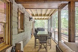 a screened in porch with a table and chairs at WolfCabin Lux Family Home, Fire Pit, Hot Tub, ADA ramp, ez paved rds in Morganton
