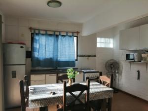a kitchen with a table and a kitchen with a refrigerator at Atlantic 10 in Atlántida