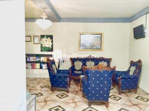 a dining room with blue chairs and a table at Hotel Indah Grogot Syariah Mitra RedDoorz in Tana Paser