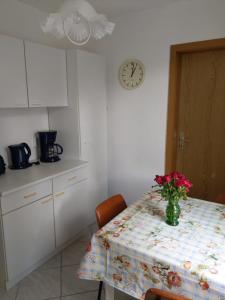 a kitchen with a table with a vase of flowers on it at Ferienwohnung Tor zur Ostsee in Mellenthin