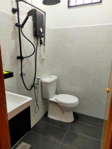a bathroom with a shower and a toilet and a sink at Kak Zai Homestay Port Dickson With Private Pool in Port Dickson +5 photos